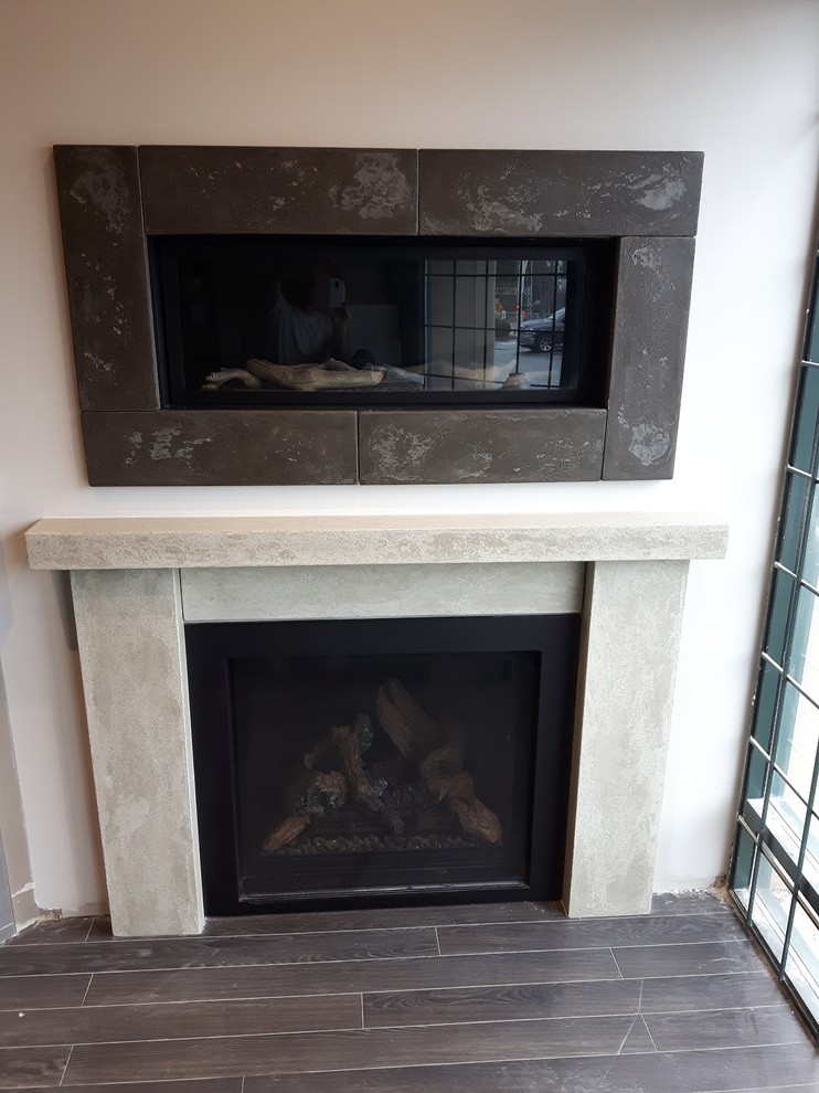 Inspiration for a classic living room in Vancouver with a concrete fireplace surround.