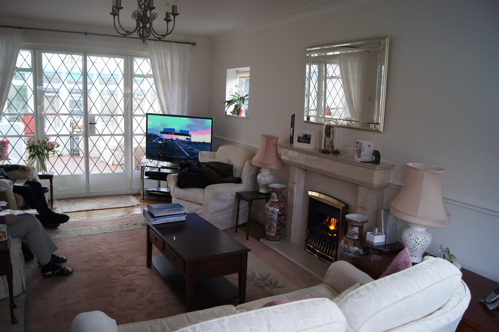 Photo of a medium sized contemporary open plan living room in Kent with white walls, carpet, a ribbon fireplace, a plastered fireplace surround, a built-in media unit and beige floors.