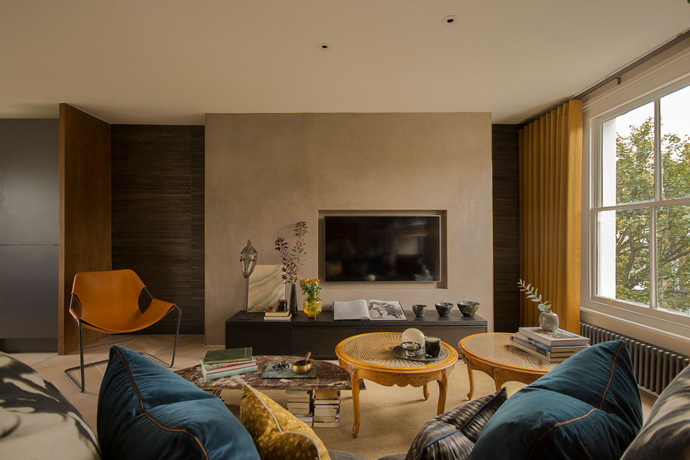 Contemporary living room in London with beige walls, a wall mounted tv and beige floors.