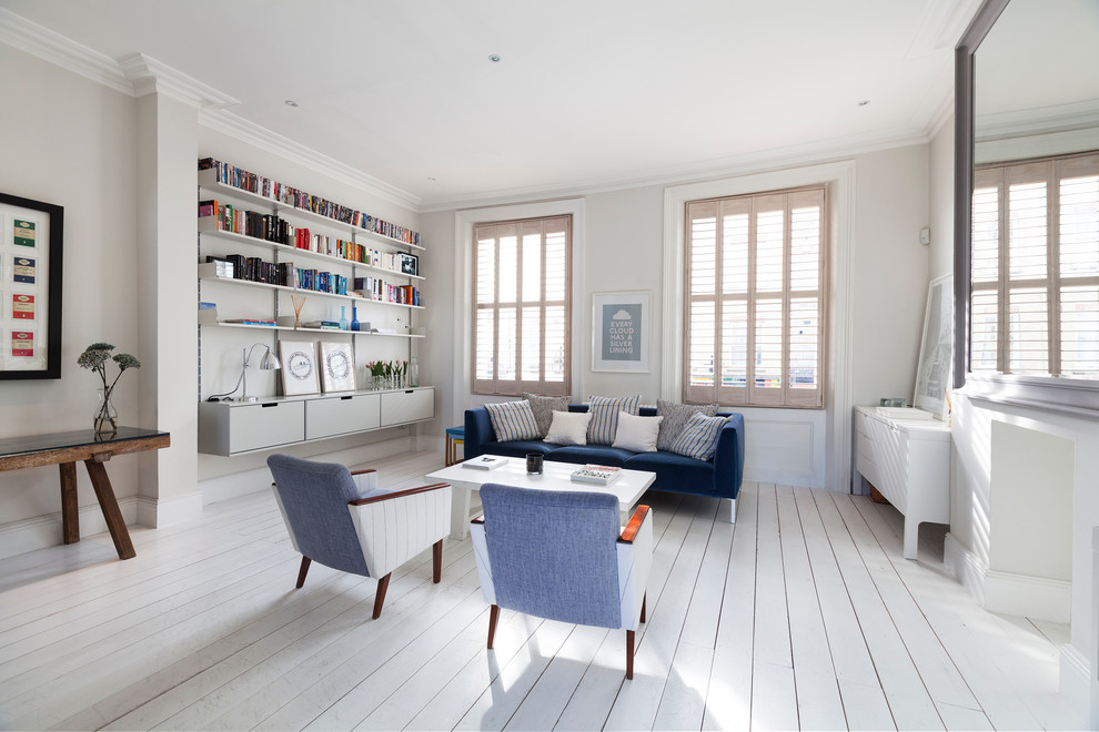 This is an example of a medium sized scandi open plan living room in London with white walls.