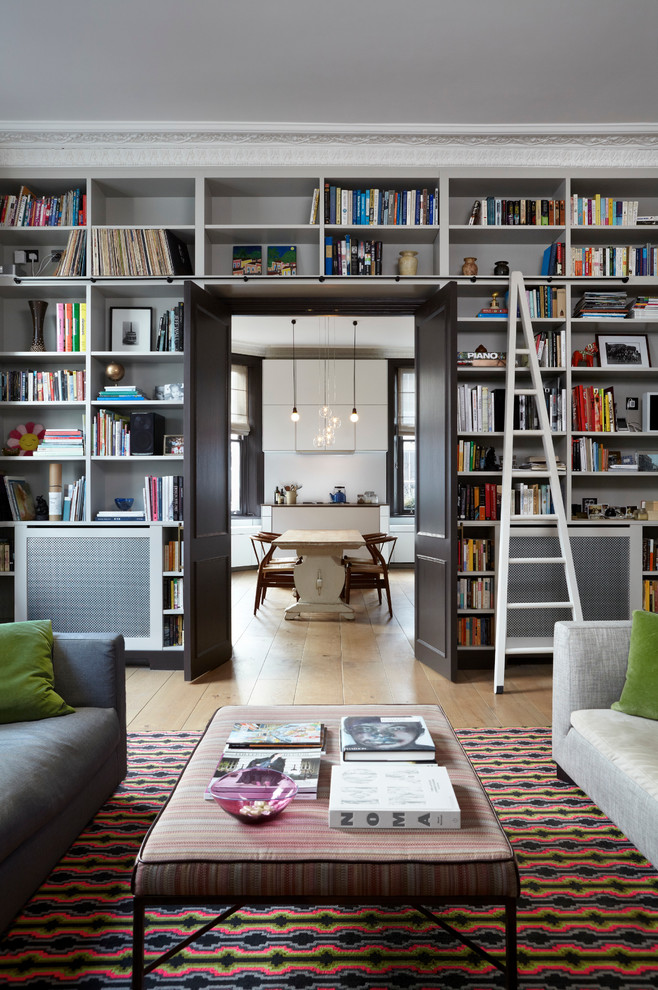Living room library - transitional living room library idea in London