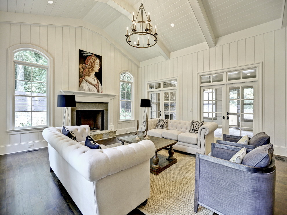 Design ideas for a traditional living room in Atlanta with a standard fireplace, a stone fireplace surround, white walls and dark hardwood flooring.