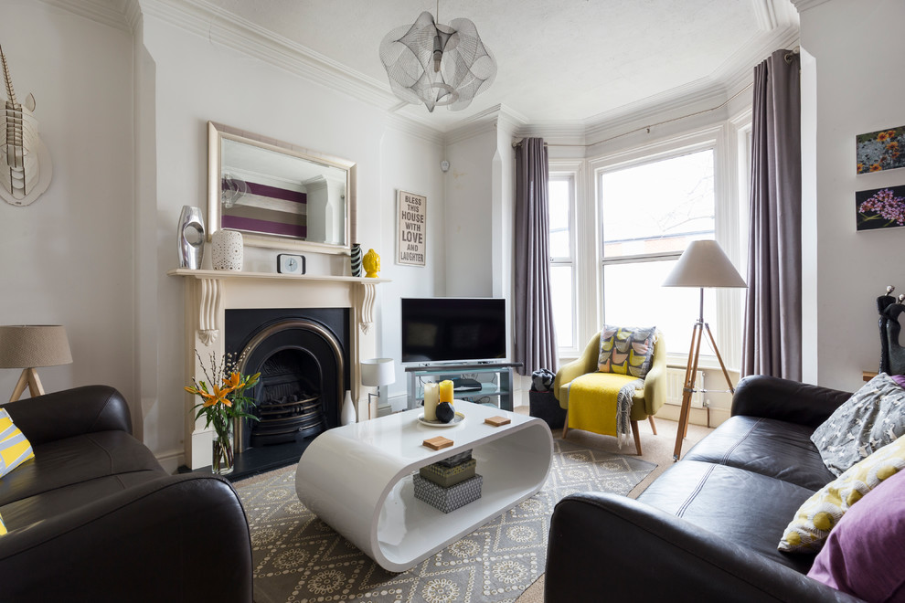 Design ideas for a classic living room in London with a standard fireplace and a freestanding tv.