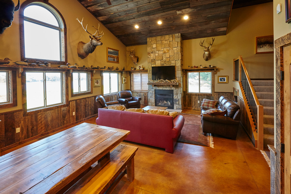 Photo of a rustic open plan living room in Minneapolis with beige walls, medium hardwood flooring, a standard fireplace, a stone fireplace surround and a wall mounted tv.