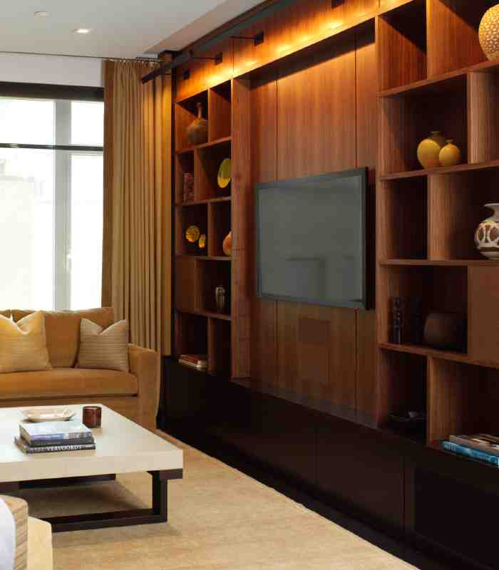 Photo of a modern formal open plan living room in New York with brown walls, dark hardwood flooring, a built-in media unit and brown floors.