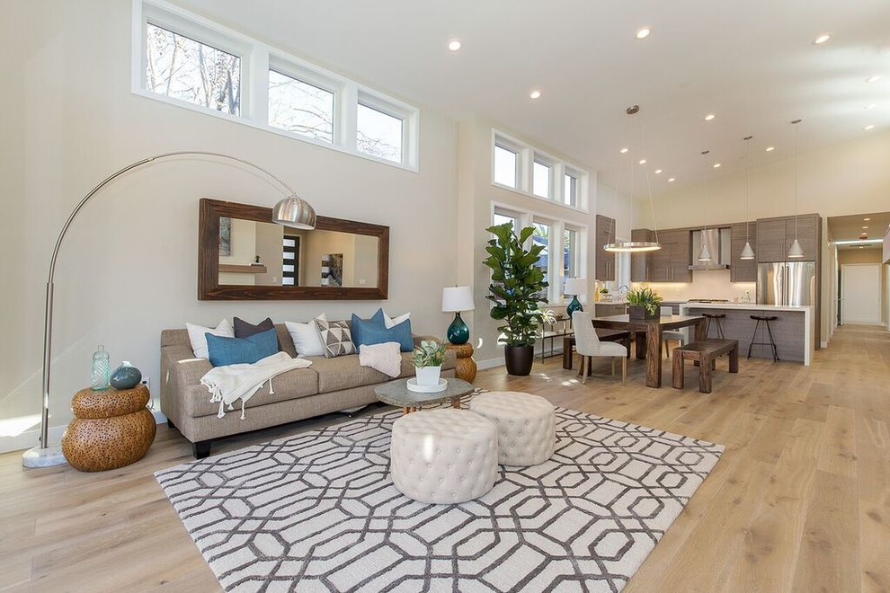 Example of a mid-sized transitional open concept and formal light wood floor and beige floor living room design in San Francisco with beige walls, a ribbon fireplace, a metal fireplace and no tv