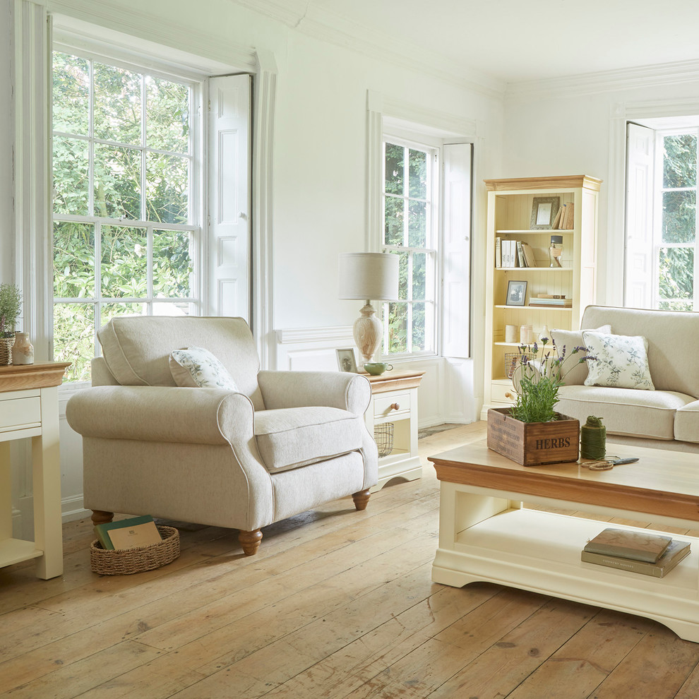 Ispirazione per un piccolo soggiorno country aperto con pareti beige e pavimento in legno massello medio