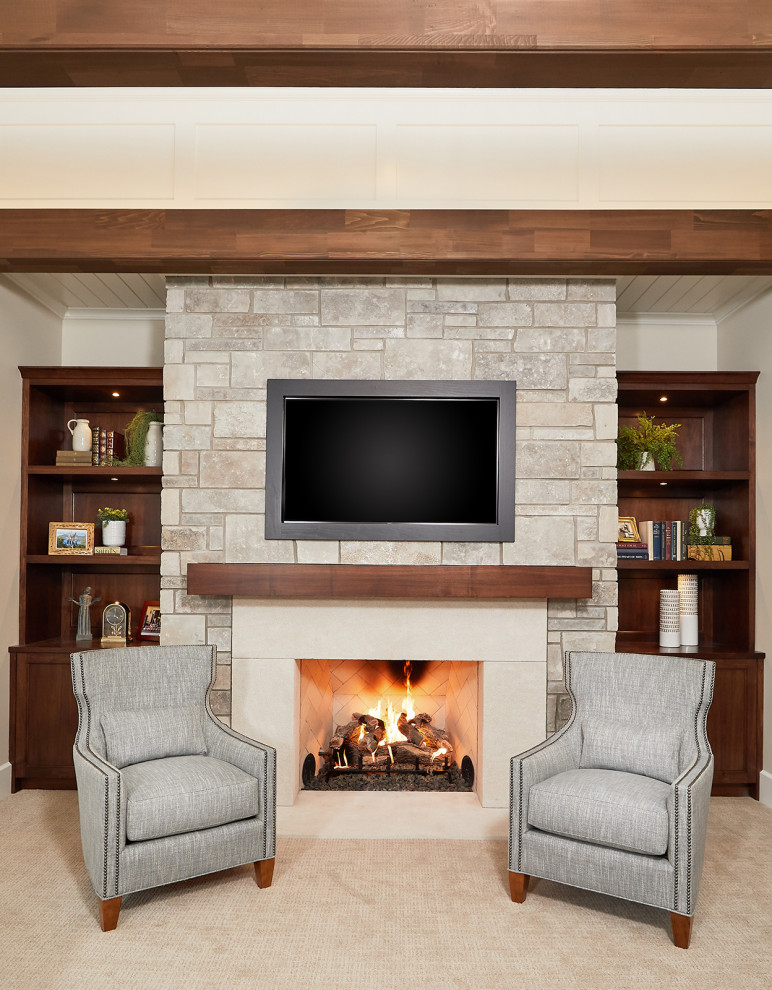 Inspiration for a timeless open concept carpeted and beige floor living room remodel in Grand Rapids with beige walls, a standard fireplace, a stone fireplace and a wall-mounted tv