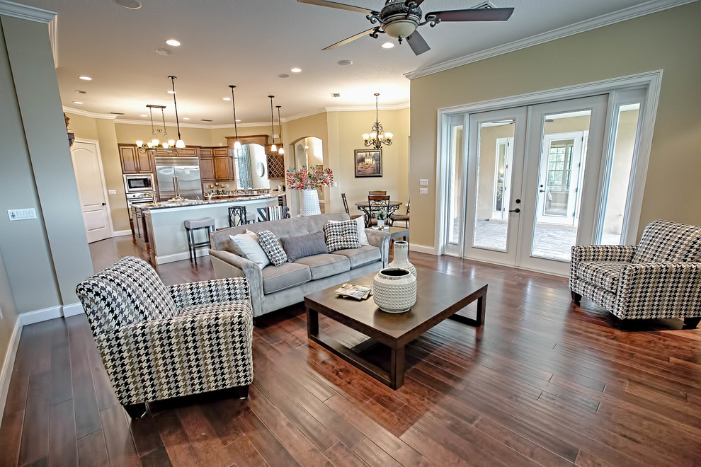 Example of a mid-sized classic formal and open concept dark wood floor and brown floor living room design in Orlando with beige walls and no fireplace