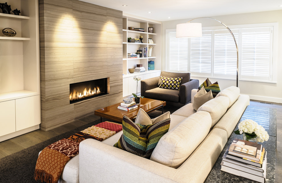 Design ideas for a medium sized contemporary open plan living room in Vancouver with white walls, light hardwood flooring, a ribbon fireplace, a stone fireplace surround and a built-in media unit.