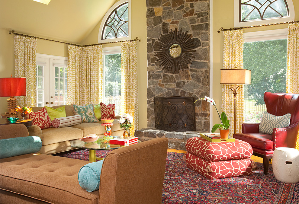Inspiration for an eclectic living room remodel in DC Metro with yellow walls, a standard fireplace and a stone fireplace