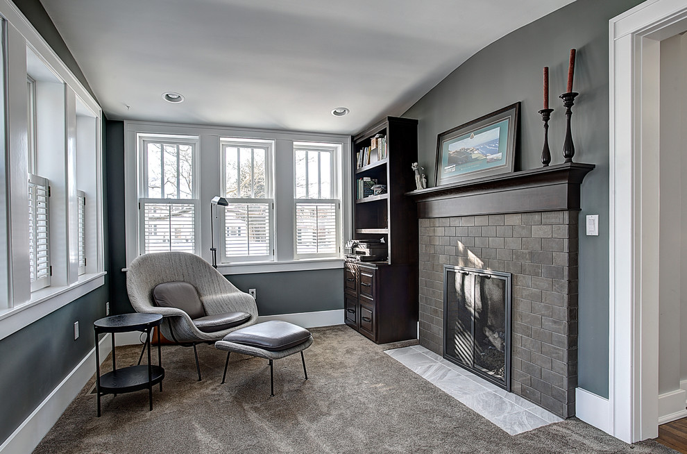 Inspiration for a small traditional enclosed living room in Grand Rapids with grey walls, light hardwood flooring, a two-sided fireplace, a stone fireplace surround and a wall mounted tv.