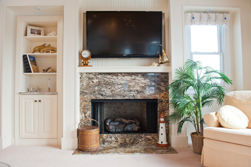Example of a mid-sized beach style open concept carpeted living room design in Other with white walls, a standard fireplace, a stone fireplace and a wall-mounted tv