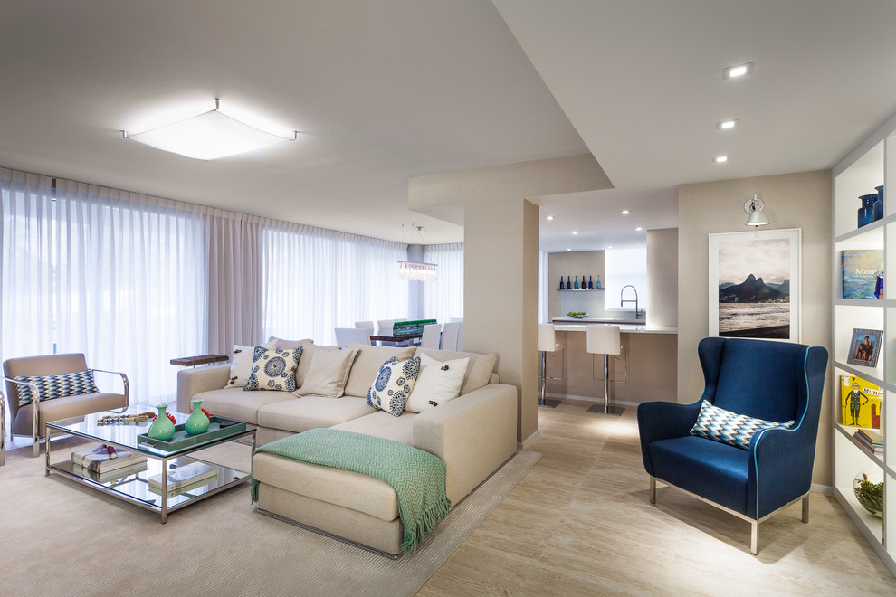 Example of a large trendy open concept travertine floor and beige floor living room design in Miami with beige walls, no fireplace and a wall-mounted tv