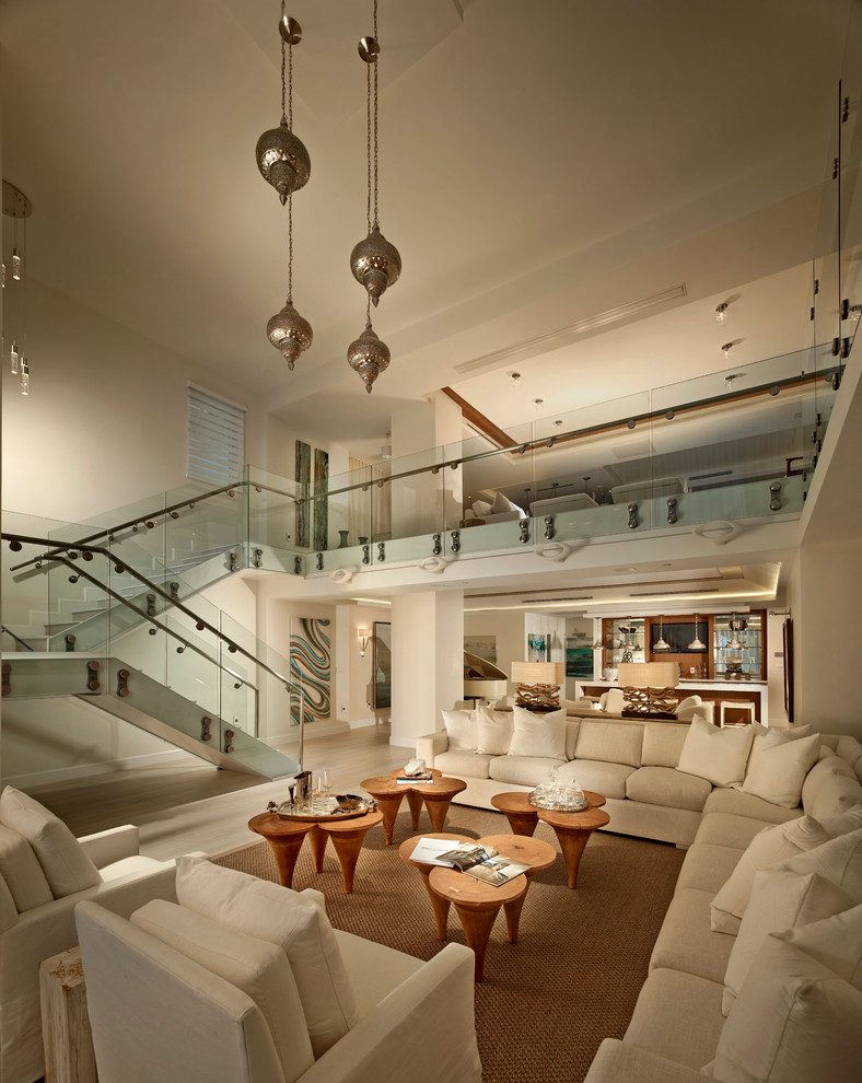 Living room - coastal open concept living room idea in Miami with beige walls