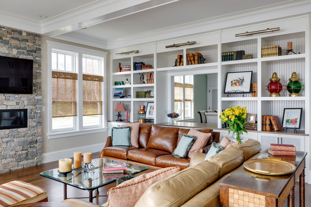 Großes, Repräsentatives, Offenes Klassisches Wohnzimmer mit beiger Wandfarbe, braunem Holzboden, Gaskamin, Kaminumrandung aus Stein und TV-Wand in Boston