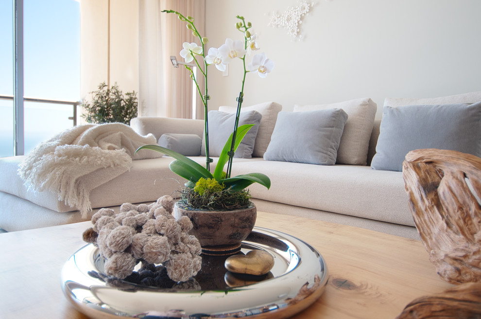 This is an example of a medium sized contemporary formal open plan living room in Los Angeles with white walls, light hardwood flooring, no fireplace and no tv.