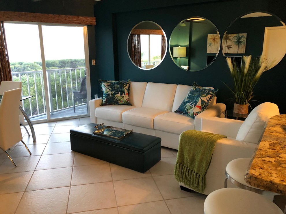 Example of a mid-sized beach style open concept ceramic tile and beige floor living room design in Boston with blue walls, no fireplace and a tv stand