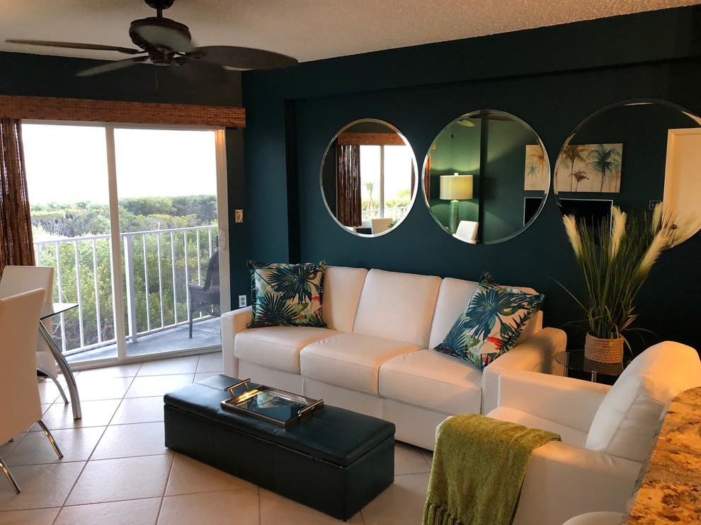Inspiration for a mid-sized tropical open concept ceramic tile and beige floor living room remodel in Boston with blue walls, no fireplace and a tv stand