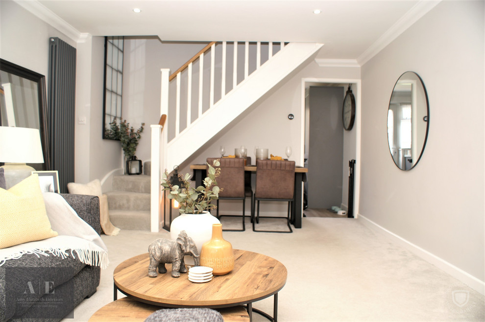 Example of a small urban formal and open concept carpeted and gray floor living room design in Hampshire with gray walls and a wall-mounted tv