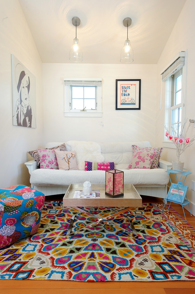 Living room - eclectic medium tone wood floor living room idea in Other with white walls
