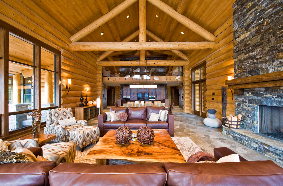 Inspiration for a rustic living room in Calgary with a stone fireplace surround.