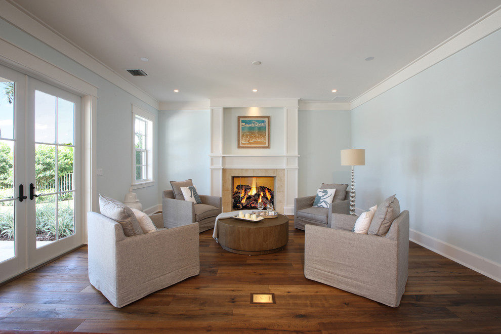 Example of a large beach style formal and enclosed dark wood floor living room design in Miami with blue walls, a standard fireplace and a tile fireplace