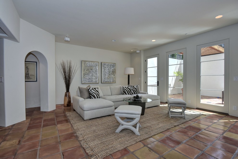 Example of a tuscan formal and open concept light wood floor living room design in San Francisco with white walls, a standard fireplace, a concrete fireplace and no tv