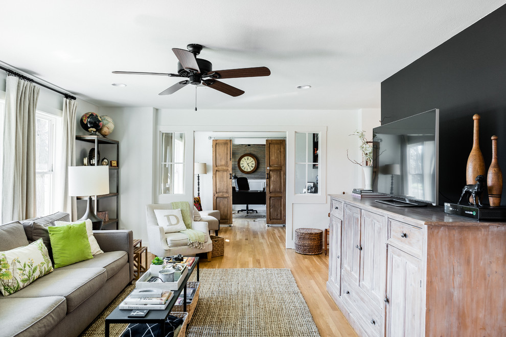 Design ideas for a medium sized traditional open plan living room in Austin with light hardwood flooring, no fireplace and a freestanding tv.