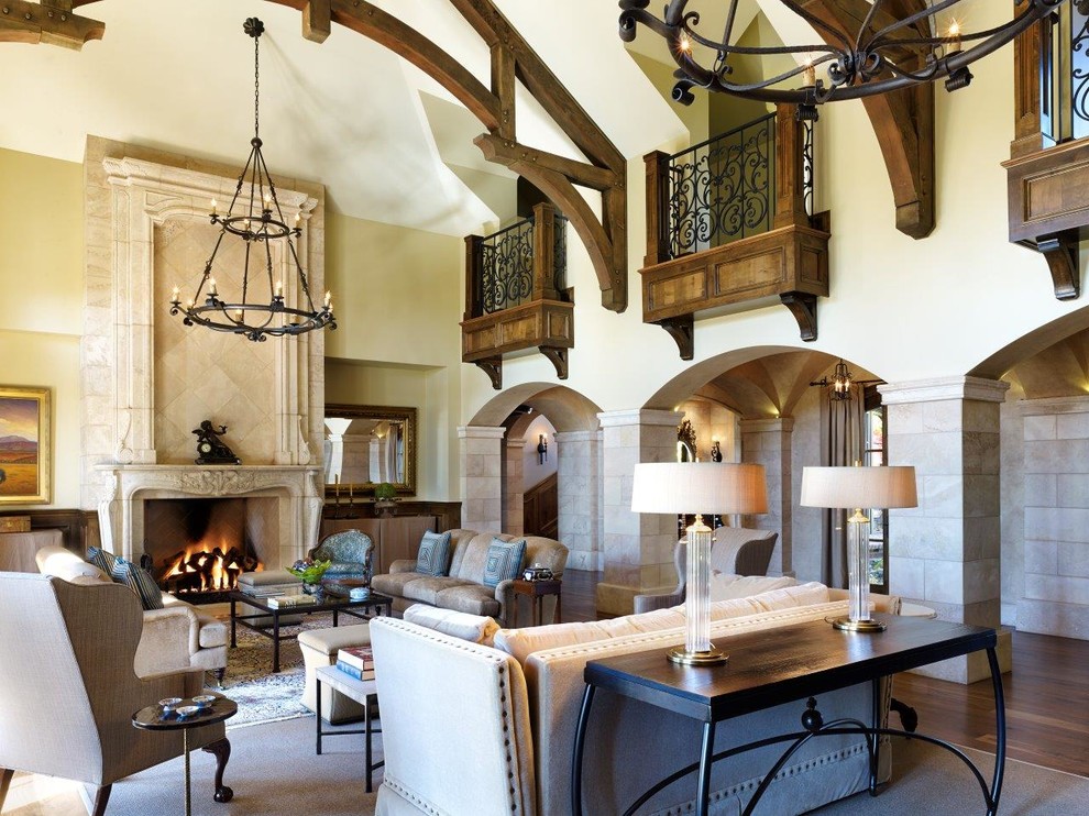 Inspiration for a huge french country enclosed and formal dark wood floor living room remodel in Denver with a standard fireplace, beige walls, a stone fireplace and no tv