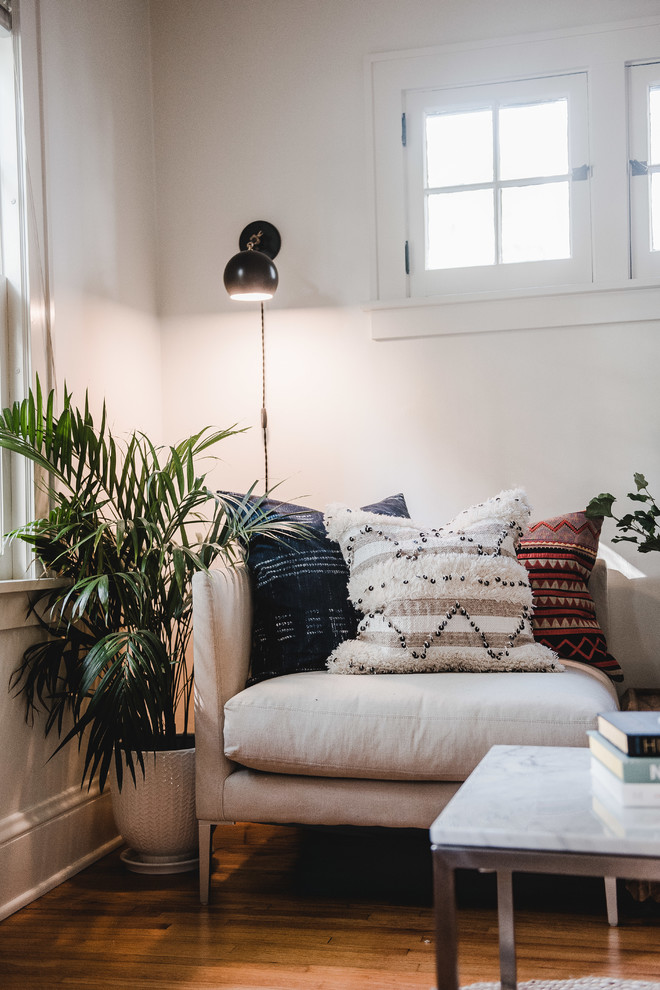 Example of a mid-sized transitional enclosed and formal light wood floor and brown floor living room design in Minneapolis with white walls, no tv and no fireplace