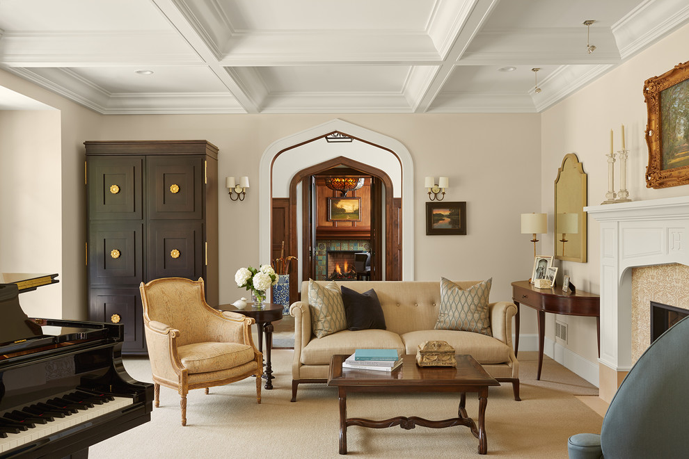 Modelo de salón con rincón musical tradicional con paredes beige, moqueta, todas las chimeneas y suelo beige