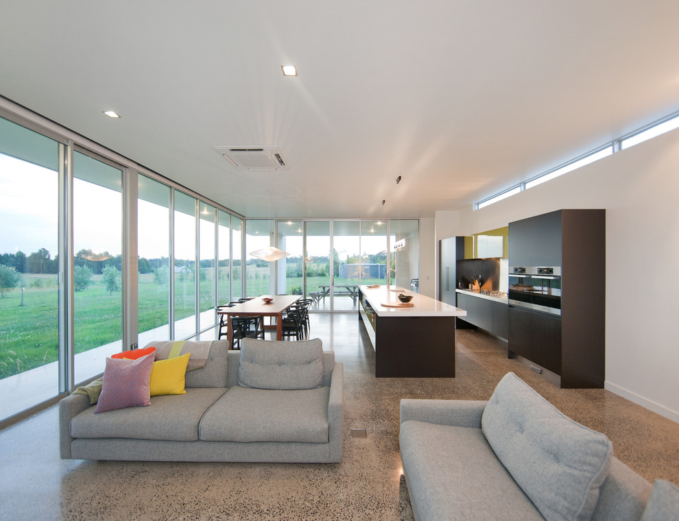 Design ideas for a modern open plan living room in Melbourne with concrete flooring.