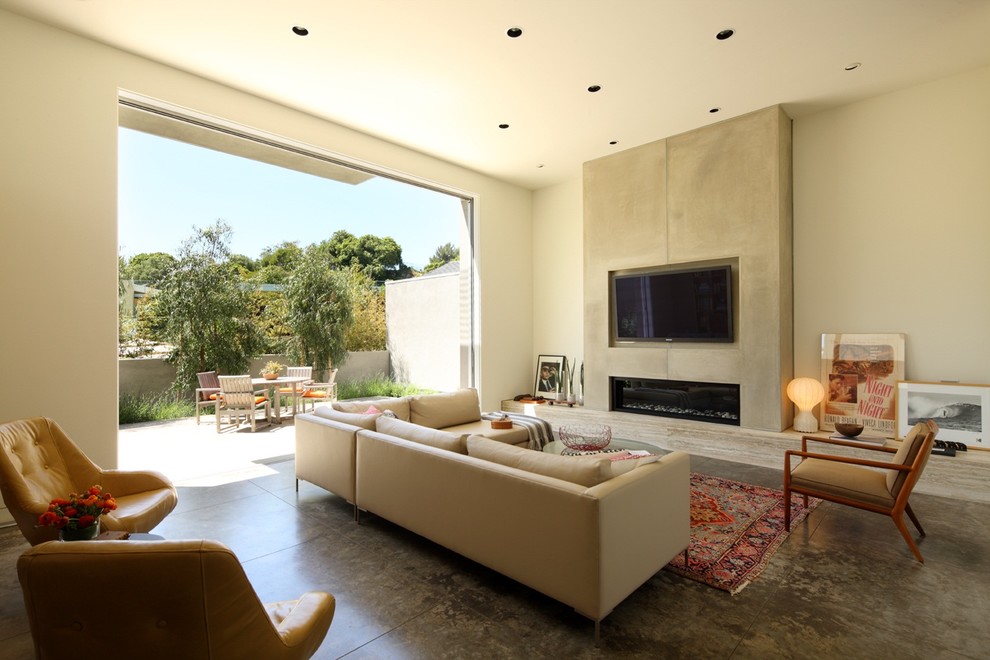 Inspiration for a contemporary living room in Los Angeles with a concrete fireplace surround.