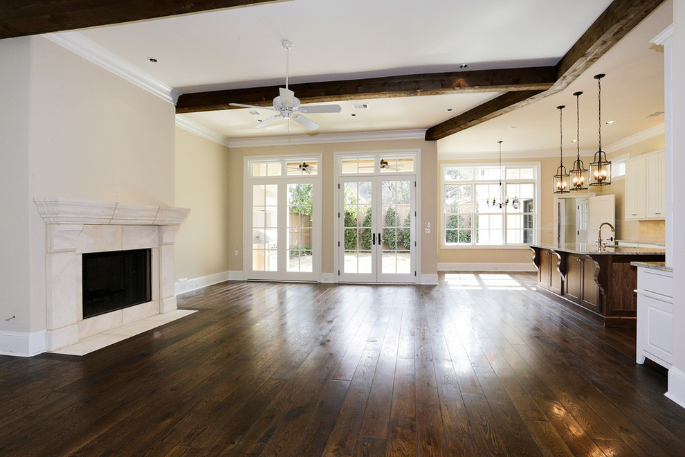 Example of a mid-sized classic formal and open concept dark wood floor living room design in Houston with beige walls, a standard fireplace, a stone fireplace and a wall-mounted tv