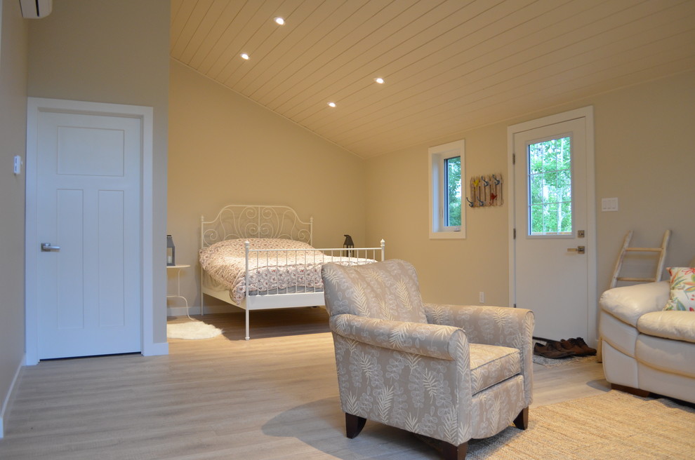 Immagine di un soggiorno moderno di medie dimensioni e aperto con pareti beige, pavimento in laminato e TV autoportante