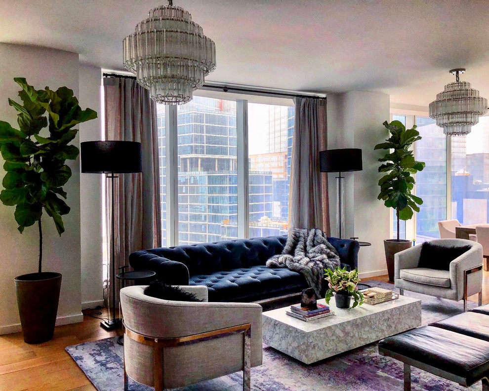 Photo of a large contemporary formal open plan living room in New York with white walls, light hardwood flooring, no fireplace, a wall mounted tv and brown floors.