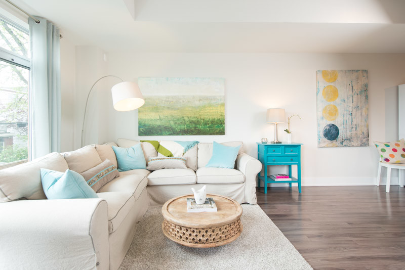 Cette image montre un petit salon design ouvert avec un mur blanc et un sol en bois brun.