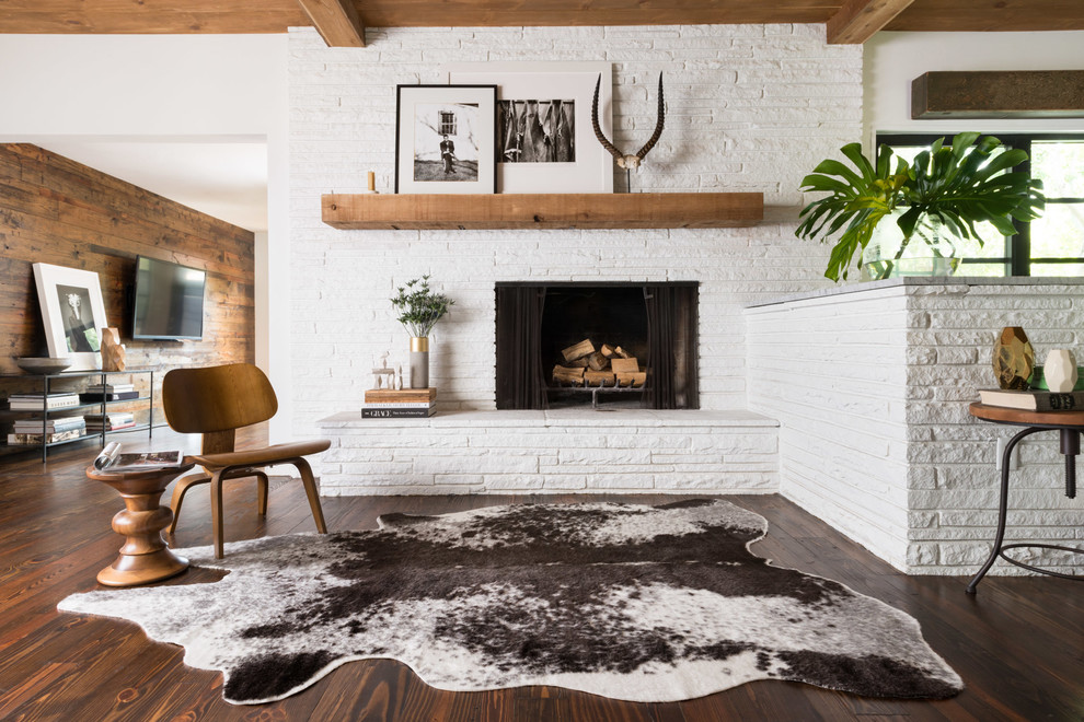 This is an example of a medium sized contemporary open plan living room in Boston with dark hardwood flooring, a stone fireplace surround, white walls and a standard fireplace.