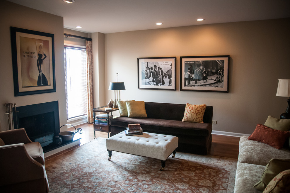 This is an example of a small classic enclosed living room in Chicago with beige walls, medium hardwood flooring, a standard fireplace, a stone fireplace surround and no tv.