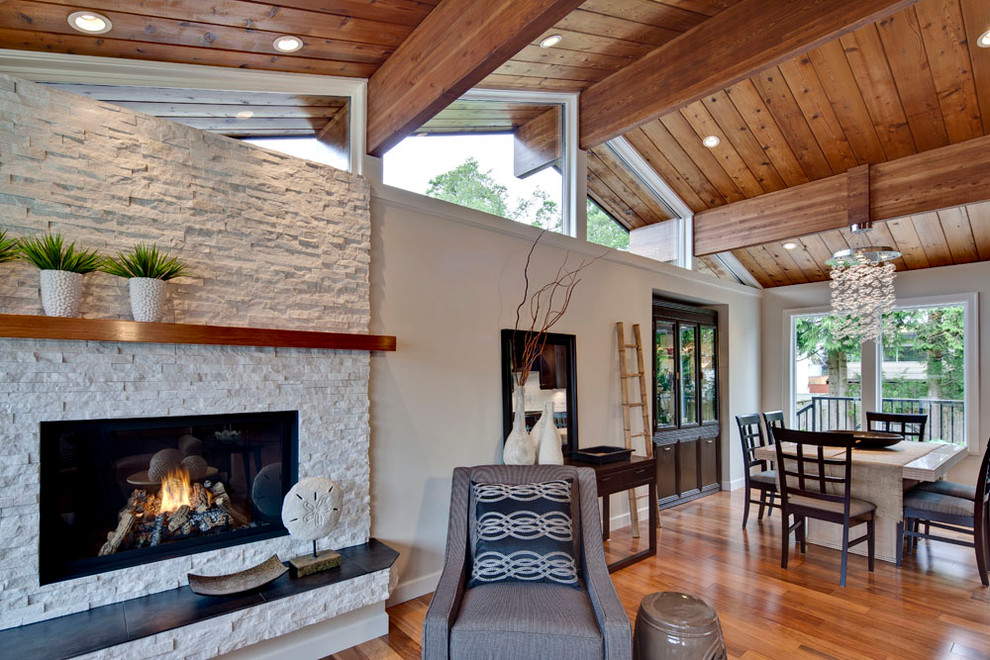 Example of a mid-sized transitional open concept medium tone wood floor living room design in Vancouver with beige walls, a stone fireplace, no tv and a ribbon fireplace