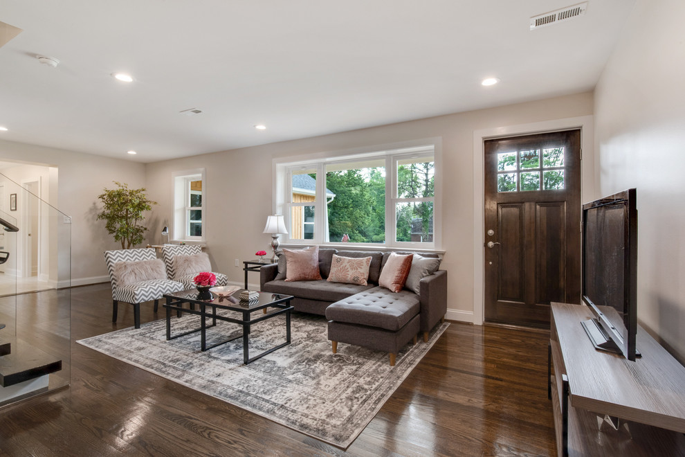 Large traditional open plan living room in Wilmington with beige walls, dark hardwood flooring and brown floors.