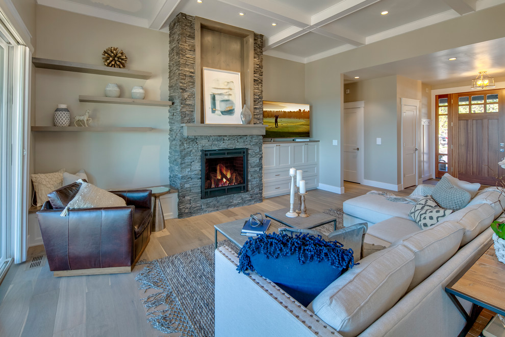 Inspiration for a mid-sized craftsman formal and open concept medium tone wood floor and brown floor living room remodel with beige walls, a standard fireplace, a stone fireplace and a tv stand