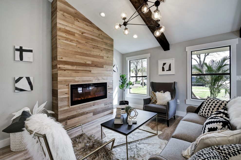 Inspiration for a medium sized contemporary living room in Austin with grey walls, a ribbon fireplace and brown floors.