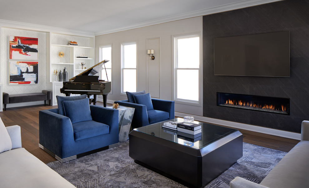 This is an example of a medium sized classic formal open plan living room in Los Angeles with black walls, medium hardwood flooring, a ribbon fireplace, a stone fireplace surround, a wall mounted tv and multi-coloured floors.