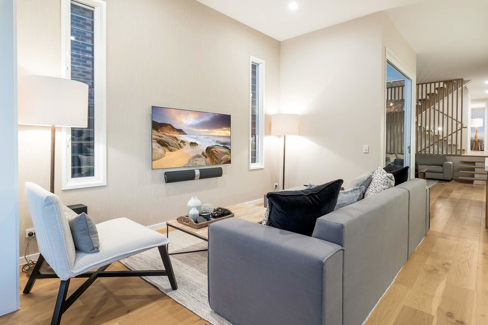 Medium sized contemporary open plan living room in Gold Coast - Tweed with beige walls, light hardwood flooring, no fireplace, a built-in media unit and brown floors.