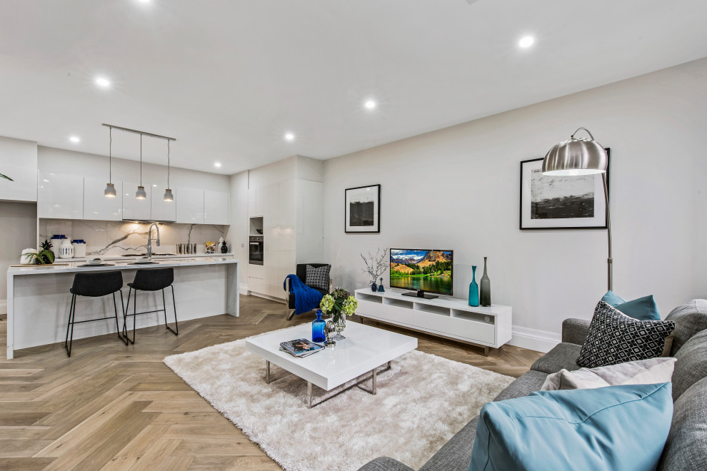 Foto di un soggiorno contemporaneo di medie dimensioni e aperto con pareti bianche, pavimento in legno massello medio, TV autoportante, pavimento beige e sala formale