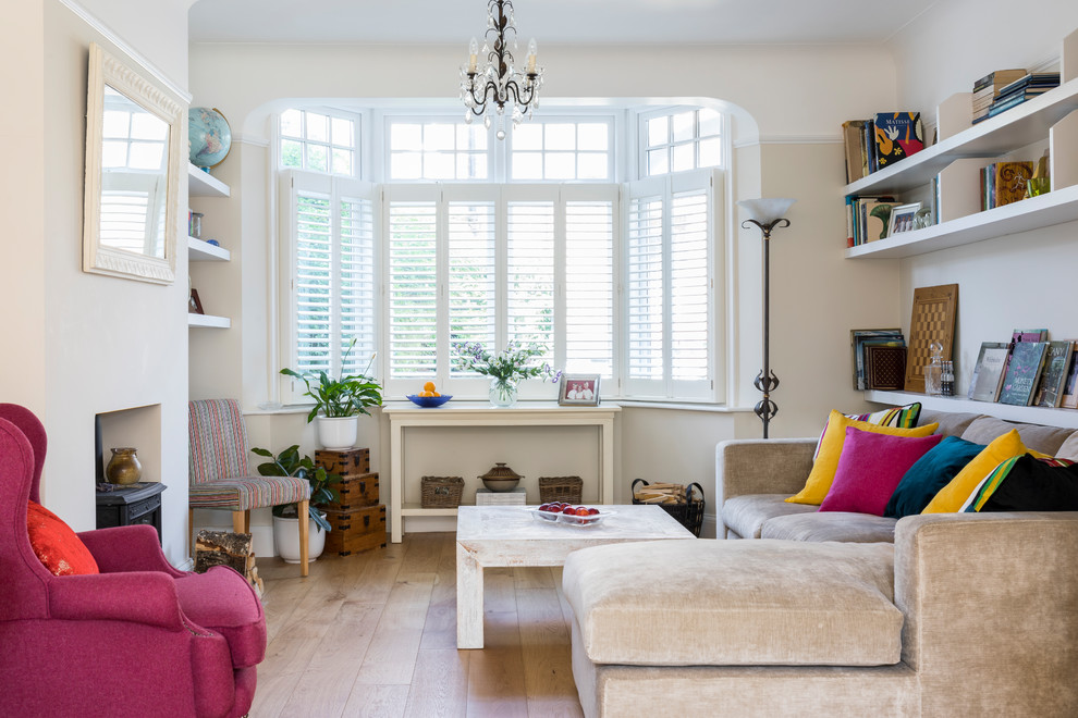 Living room - small eclectic enclosed light wood floor and beige floor living room idea in London with a wood stove