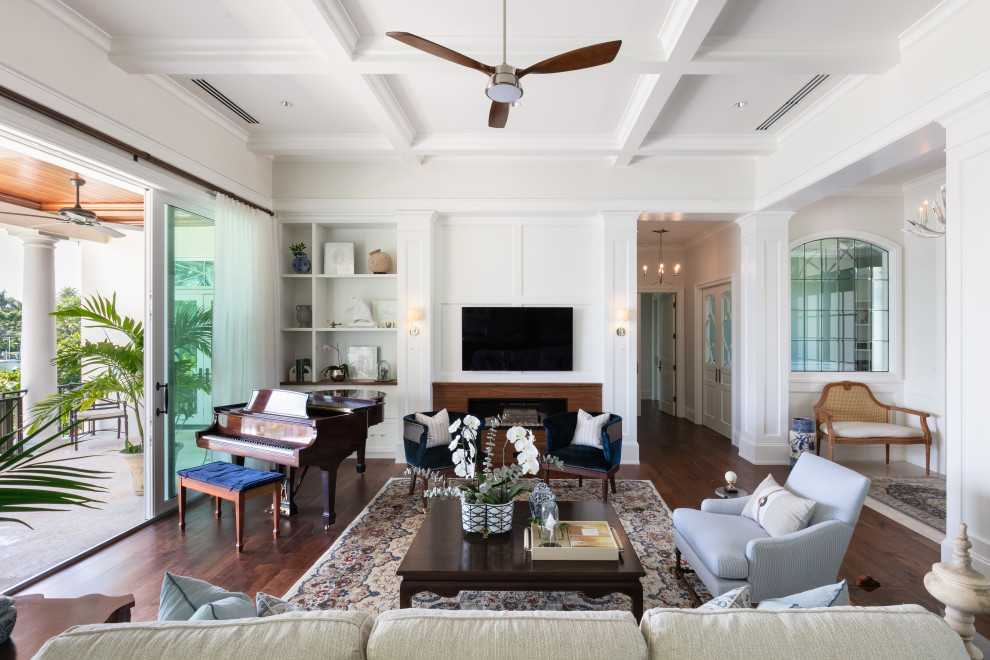 Living room - large coastal formal and open concept dark wood floor and brown floor living room idea in Tampa with white walls, a standard fireplace, a wood fireplace surround and a wall-mounted tv