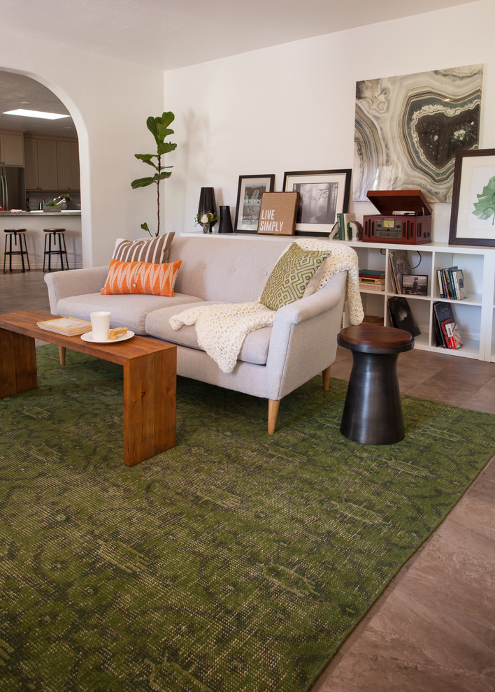 Example of a mid-sized eclectic enclosed porcelain tile living room design in Phoenix with white walls and no tv
